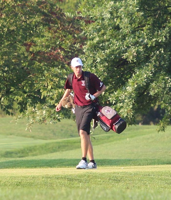 Caleb Davis walking to his next shot carrying his clubs