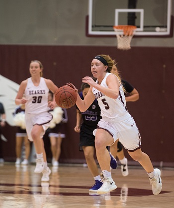 CofO''s #5 Kelsie Cleeton dribbling down the court with #30 Lakin Simmerman in the background