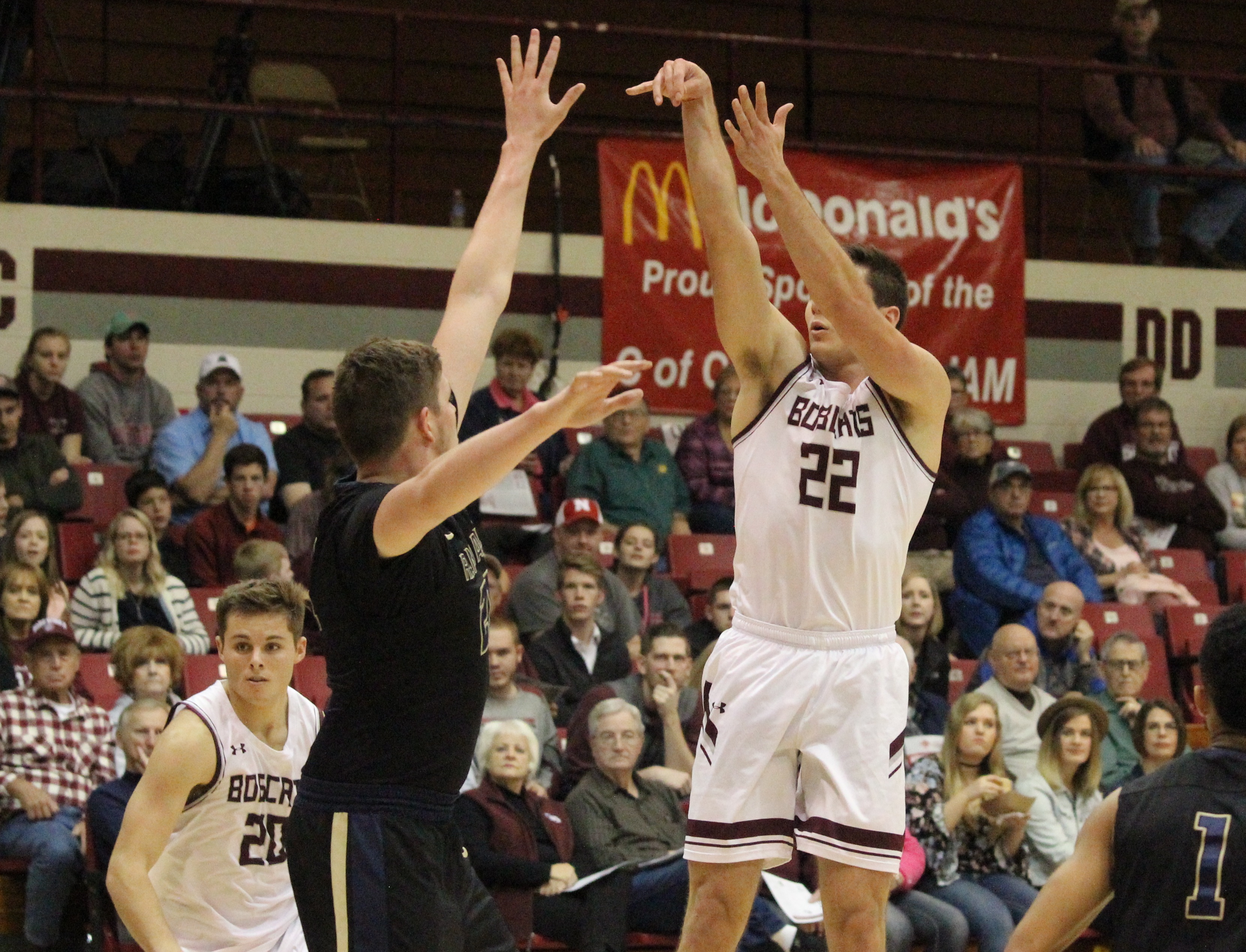 Ethan Davidson #22 taking a three point shot with #20 Storm Price in the pic