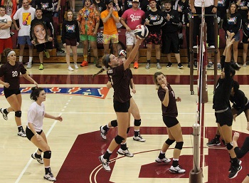 Acton shot from season with Kayli Grant hitting the ball over the net
